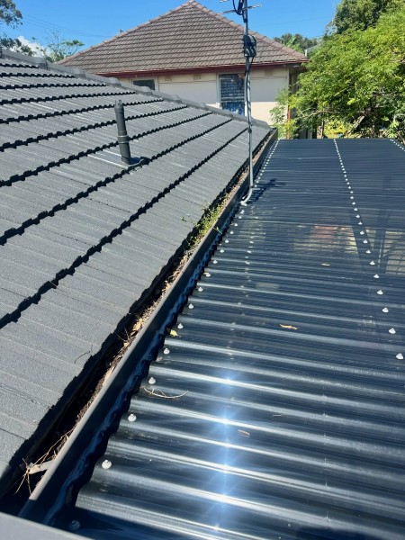 Damaged metal roof flashing identified during a leak inspection Illawarra