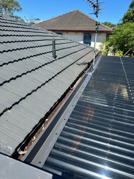 Damaged metal roof flashing repaired following a leak inspection